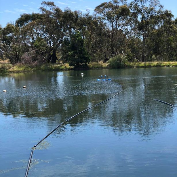 Two irrigation pumps used in a lake attached to a long hose